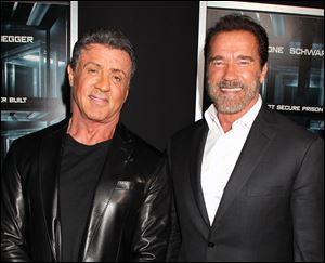 Sylvester Stallone, left, and Arnold Schwarzenegger attend the premiere of 