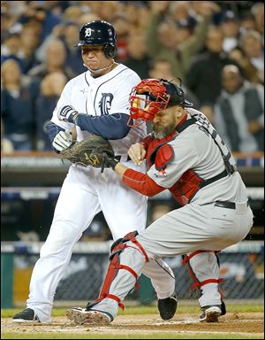 The Tigers' Miguel Cabrera is tagged out at home by Red Sox catcher David Ross in the first inning during Game 5 of the American League championship series on Thursday.