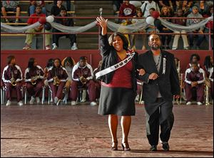 Treva Jeffries, Scott's principal and 1992 homecoming queen, acknowledges the crowd while being escorted by Dameon Austin, the 1992 homecoming king. 