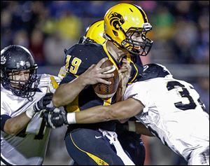 Perrysburg's Kyle Recker sacks Northview's Brendan Pierson as Matt Mesker moves in. The Yellow Jackets are 6-2, 5-0 in the NLL.