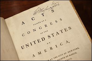 'Acts Passed at a Congress of the United States of America,' which belonged to George Washington and features his signature at the top right, now resides in the Rare Books Vault of the new library.