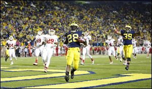 University of Michigan player Fitzgerald Toussaint (28) scores a touchdown against Indiana University during the fourth quarter.