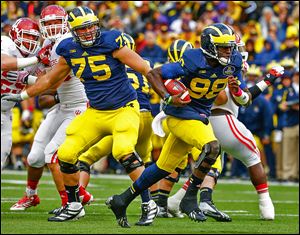 Michigan quarterback Devin Gardner, who completed 21 of 29 passes for 503 yards, runs for a touchdown against Indiana.