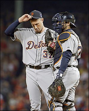 Tigers starting pitcher Max Scherzer, left, talks to catcher Alex Avila after walking Boston Red Sox's Dustin Pedroia in the sixth.