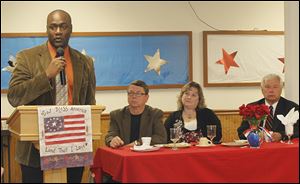 Aji Green, a candidate for the Toledo Board of Education, speaks at a candidates’ breakfast on Saturday. Seated, from left, are Rob Ludeman, Chris Varwig, and James Nowak. 
