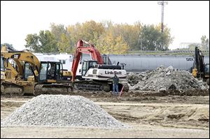 Crews work along the site of the warehouse being built at the $18 million Ironville development in East Toledo.
