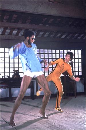 Martial artist Bruce Lee, right, and basketball star Kareem Abdul-Jabbar are shown in a karate scene from the 1978 movie 'Game of Death.'