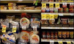 Tortillas and other items are seen in the International food aisle of a grocery store.