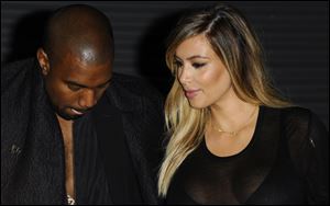 Kanye West, left, and Kim Kardashian  are seen in Paris in September.