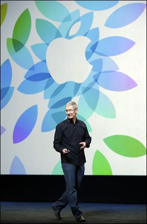 Apple CEO Tim Cook speaks on stage before a new product introduction today San Francisco.