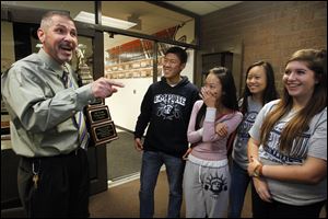 Principal Dave McMurray, left, congratulates some of the members of the mock trial team. From left: Eric Zhu, Catherine Dong, Lily Yan, and Claire Coder.