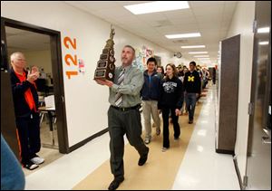 Principal Dave McMurray, center, holds up a trophy while leading Southview students who won a Mock Trial team competition over the weekend in New York.