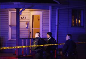 Police on the scene where a woman was shot at 658 Spring Street Wednesday in Toledo.