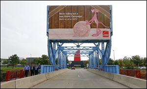 Owens Corning paid a hefty price to Metro-Goldwyn-Mayer Studios in 2007 for rights to continue using the Pink Panther character in the marketing of its products for another 15 years. Here, a sign touts OC products on the bridge leading to its headquarters. 