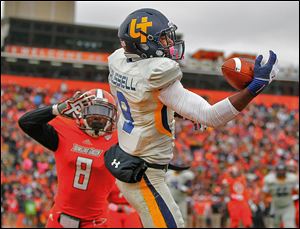 Toledo receiver Alonzo Russell makes a one-handed catch for a touchdown over Bowling Green State's Cameron Truss during the second quarter. It was the first conference lost for the Falcons.
