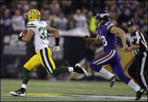 Green Bay Packers cornerback Micah Hyde, left, runs past Minnesota Vikings punter Jeff Locke for a touchdown in a return in the first half Sunday in Minneapolis.