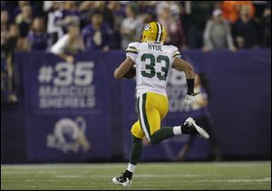 Green Bay Packers cornerback Micah Hyde runs to the end zone for a touchdown on a 93-yard punt return in the first half against the Minnesota Vikings on Sunday.