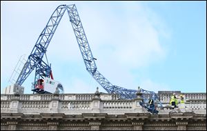 Engineers look at the damage as a crane working on redevelopment at the Cabinet Office in Whitehall, near to Downing Street in London, was brought down by high winds today.
