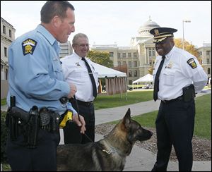 Toledo Police Chief Derrick Diggs, right, with one of the department's  German shepherds and two other members of the force.