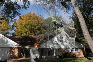 Paul and Noelle Zeisler, of West Toledo, have home built almost all their Halloween decorations, including a 20 foot tall spider web with a mummy in its center. Paul builds the spider web each year from scratch, using PVC pipe, rope and bagged cobwebs. He estimates the cost of building the web new each year to be between $75 and $100.
