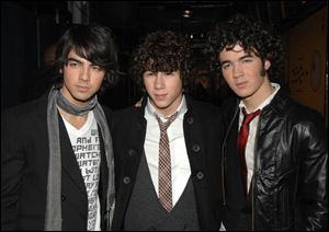 Joe Jonas, left, Nick Jonas and Kevin Jonas, right, of the music group The Jonas Brothers.