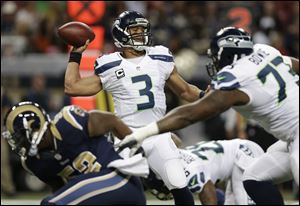 Seattle Seahawks quarterback Russell Wilson (3) works against the St. Louis Rams during the first half.