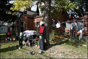 Jane Ochoa, of North Toledo, has spent the better part of a week assembling and putting up her various Halloween decorations. With everything ranging from skeletons to aliens to the Wicked Witch, Ochoa's front yard is ready for the holiday. 
