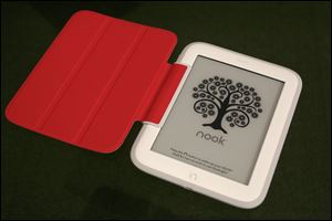 Barnes & Noble's new e-reader, Nook GlowLight, is demonstrated in New York. The GlowLight has an electronic ink touch screen, which has better battery life and less glare than typical tablet screens. The red cover is an optional accessory. 