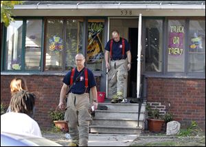Toledo firefighters leave a home at 538 Geneva Avenue in Toledo, following a fire in which two children were reported burned.