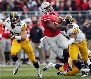 Ohio State’s Carlos Hyde gets past Iowa’s Anthony Hitchens, right. Hyde has 590 yards on 88 carries with seven touchdowns this year.