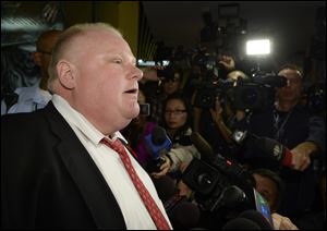 Mayor Rob Ford talks to media at City Hall in Toronto on Thursday.