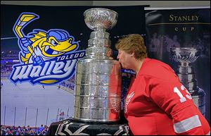 The Stanley Cup gets a smooch from  Shari Hartman of Holland, Ohio. The hardware was on display before the Walleye game on Saturday.