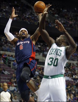 Detroit Pistons forward Josh Smith takes a shot against Boston Celtics forward Brandon Bass during the second half Sunday in Auburn Hills, Mich. Smith scored 15 points and pulled down seven rebounds in a 87-77 win.