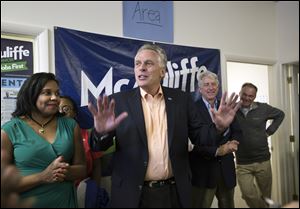 Virginia gubernatorial candidate Terry McAuliffe, center, speaks to his supporters and encourages them to make the final push by knocking on door-to-door to get more votes on Saturday in Norfolk, Va. 
