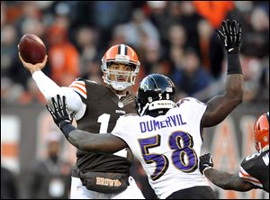 Browns quarterback Jason Campbell fires a touchdown pass over the Ravens’ Elvis Dumervil. He had three touchdown passes.
