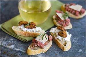 Crostini topped with goat cheese and candied nuts or steak tartare.