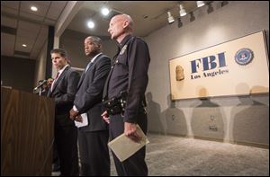 From left, FBI Special Agent in Charge David L. Bowdich, United States Attorney Andre Birotte Jr., and Los Angeles Police Department Commander Andrew Smith in a news conference to provide an update on the investigation of the shooting incident at Los Angeles International Airport Saturday.