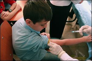 A Syrian student receives a vaccination as part of a UNICEF-supported vaccination campaign at a school in Damascus.
