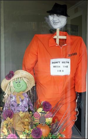 An Al Capone scarecrow decorates the window of Spring Valley Business Solutions in Whitehouse.