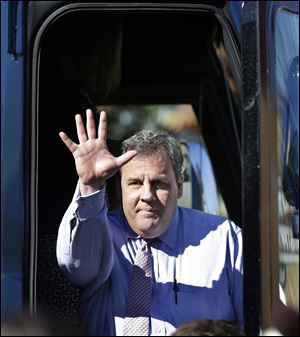 New Jersey Gov. Chris Christie waves to supporters during a campaign stop today in Hillside, N.J. Christie will face Democratic candidate, Barbara Buono in an election Tuesday.