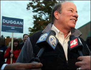 Detroit mayoral candidate Mike Duggan speaks to the media following voting with his family at the 12th Police Precinct in Detroit today.