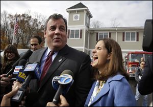 New Jersey first lady, Mary Pat Christie, laughs as husband, Republican New Jersey Gov. Chris Christie, jokes with the media after they voted in Mendham Township, N.J., Tuesday.