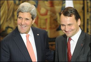 U.S. Secretary of State John Kerry, left, and Polish Foreign Minister Radek Sikorski share a light moment after a news conference following their talks in Warsaw, Poland.