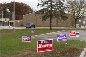 Political signs dot the drive up to McCord Junior High School’s polling location in Sylvania. John Jennewine retained his seat on the Sylvania Township Board of Trustees with 27 percent of the vote. John Crandall finished second in the race.