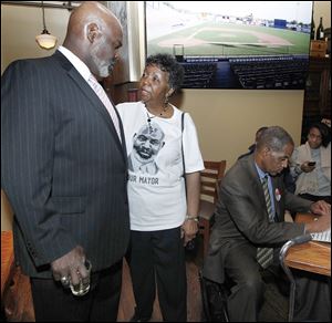 Toledo Mayor Mike Bell speaks to his mother, Ora Bell, during his election-night party at Table Forty 4. Democrat Peter Ujvagi believes one reason Mr. Bell lost is the condition of Toledo’s neighborhoods.