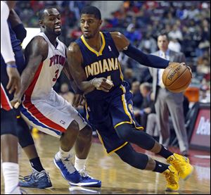 Detroit Pistons guard Rodney Stuckey (3) tries to stay with Indiana Pacers forward Paul George, right, during the first half.