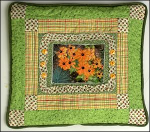 Black-eyed susans on a pillow by quilter Judy Paschalis is among 28 art quilts on display at Downtown Latte in November. A public reception is set for 11 a.m to 1 p.m. Saturday. 