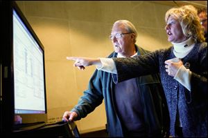 TPS board member Lisa Sobecki points to a screen showing results along with Sylvania resident Stan Odesky.