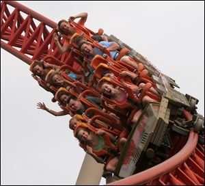 Riders enjoy the Maverick roller coaster at Cedar Point amusement park. Cedar Point's parent company, Cedar Fair, is reporting record third-quarter profits.