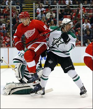 Detroit’s Joakim Andersson, left, fights for position with the Stars’ Brenden Dillon.